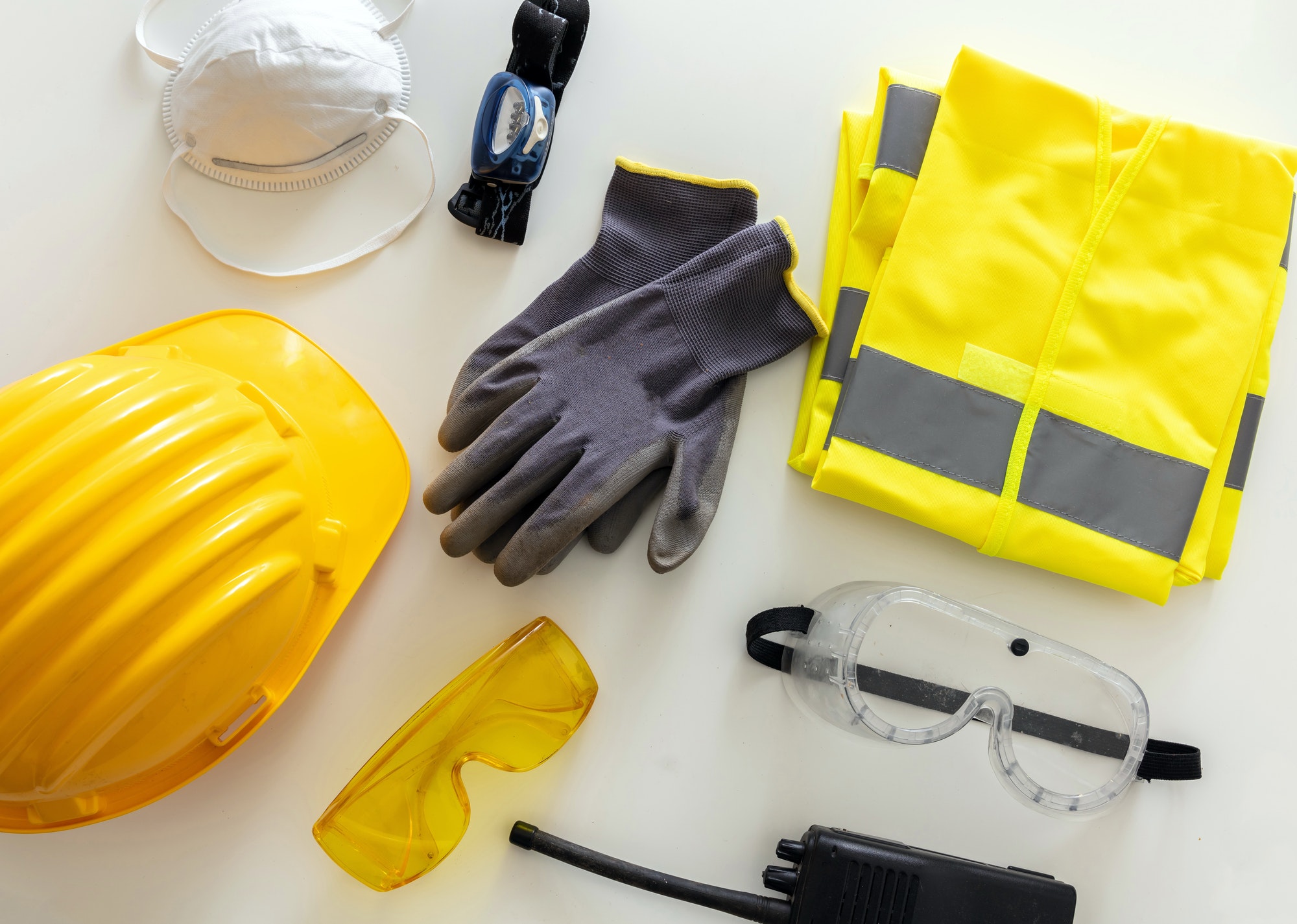 Work safety protection equipment background. Industrial protective gear on white